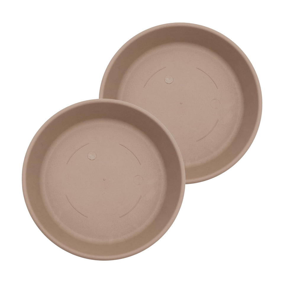 The HC Companies 14in round sandstone saucer catching excess water under a plant pot.