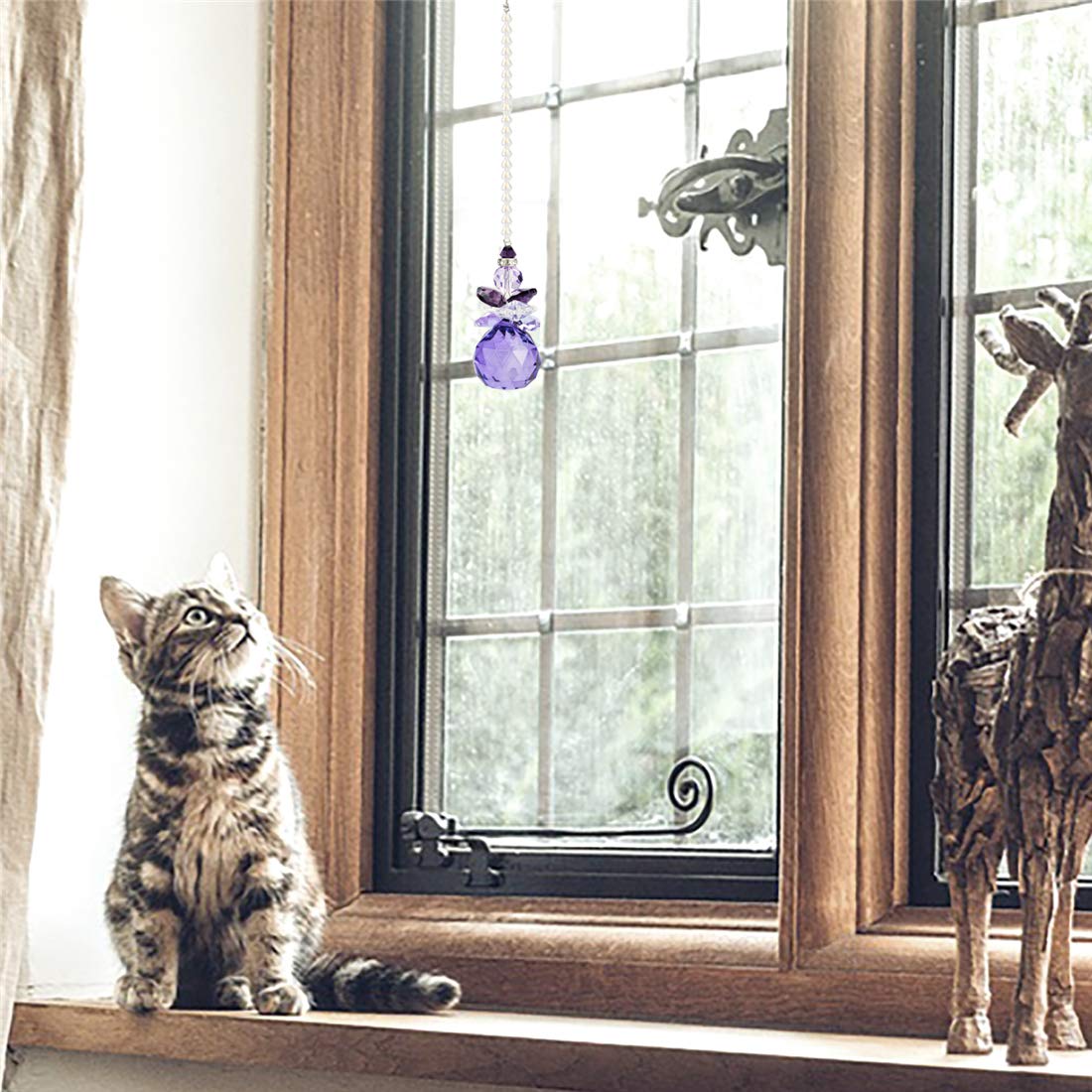 H&D interior crystal light catcher enriches decor with prismatic rainbow reflections.