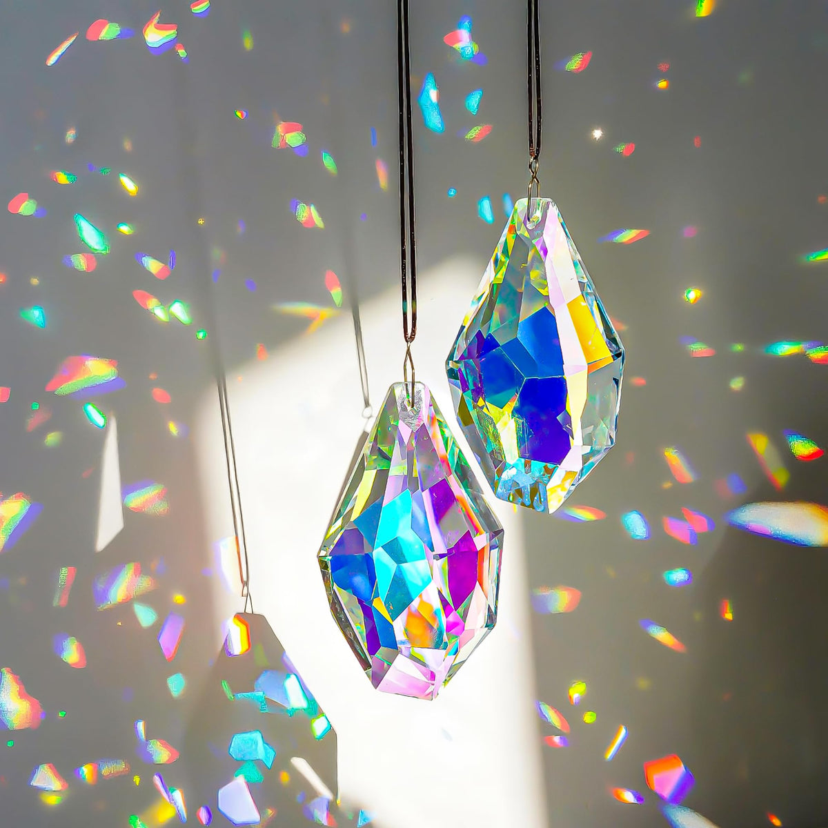 H&D Hyaline & Dora crystal sun catcher prisms viewed in sunlight, creating colorful rainbows.