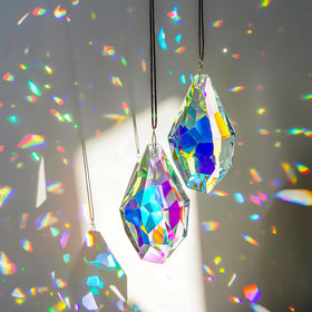 H&D Hyaline & Dora crystal sun catcher prisms viewed in sunlight, creating colorful rainbows.