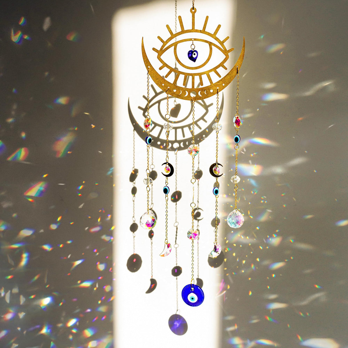 H&D HYALINE & DORA evil eye suncatcher on a window adds color reflections.