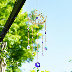 H&D HYALINE & DORA sun-moon prism suncatcher catching sunlight into rainbows.