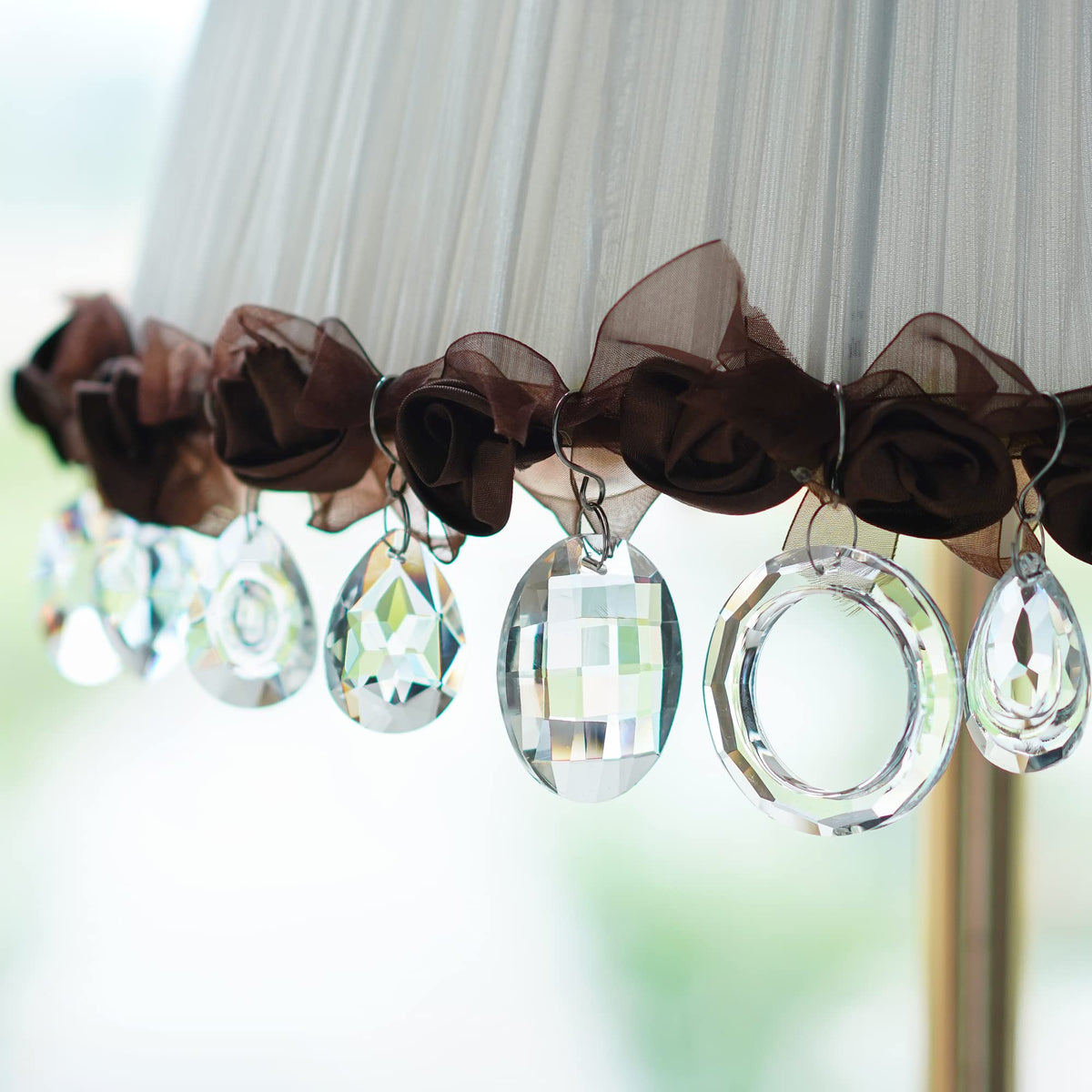 H&D HYALINE & DORA suncatcher rainbow pendant hanging in sunlight