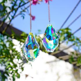 H&D Hyaline & Dora sun catcher hanging in window turning sun rays into rainbows.