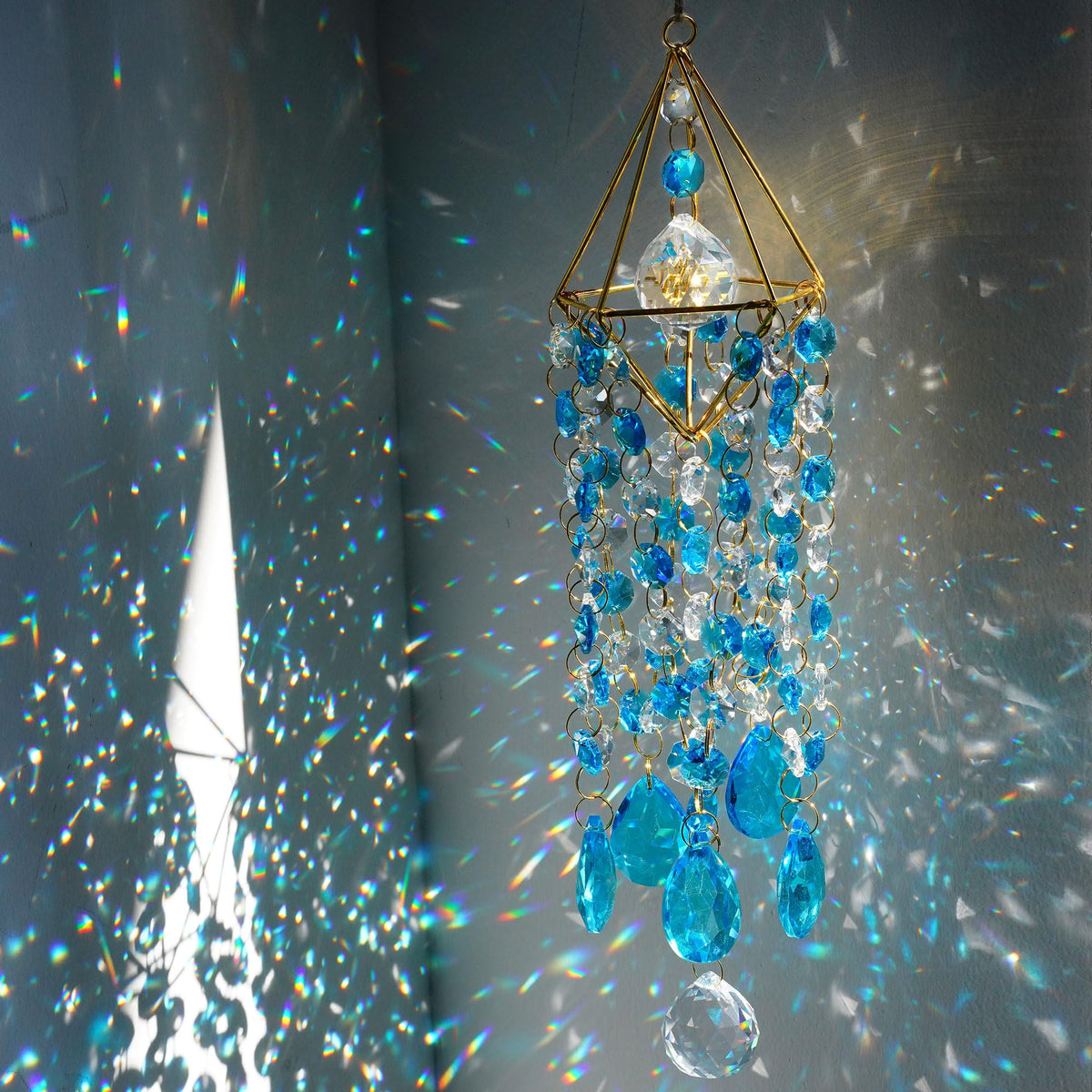 HDCRYSTALGIFTS 21.5in blue suncatcher window hanging creates vivid rainbow light indoors.