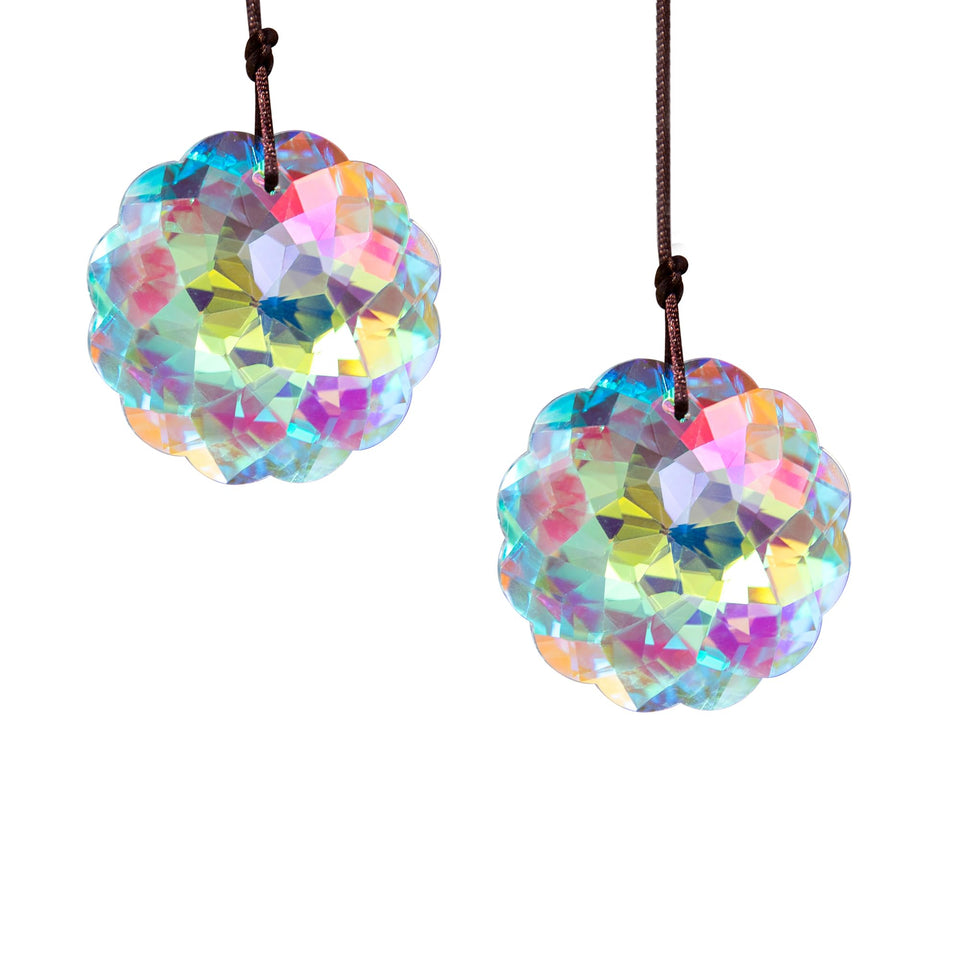 HDCRYSTALGIFTS Datura suncatcher by window casting vibrant rainbow light.