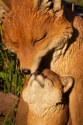 Hi-Line cuddling fox statue for outdoor spaces enhances natural charm and family-friendly vibes.