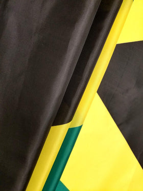 High Supply Jamaican flag close-up brass grommets and stitching detail.