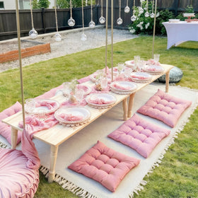 Hillsuren pink pillows offer soft seating for six around the blanket.