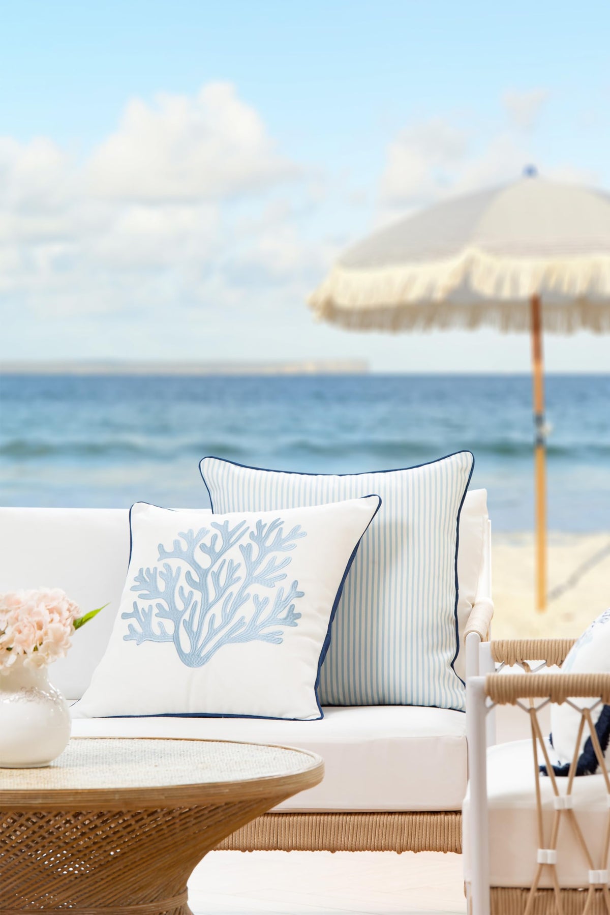 Hofdeco Premium cushion cover featuring navy piping detail for refined edge.