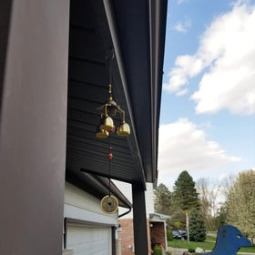Hooshing Lucky wind chimes hanging in a garden as decorative focal point