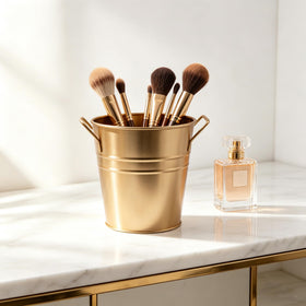 Hosley dry floral display in gold metal bucket for mantel.