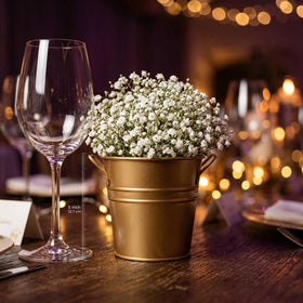 Hosley wedding decor ideas featuring gold buckets on tables.