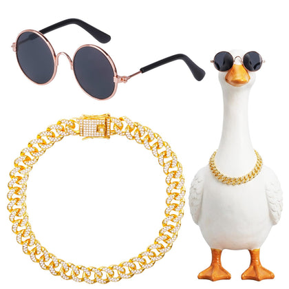 Hoyuwak goose outfit with gold rhinestone collar on a lawn statue, stylish yard decor.