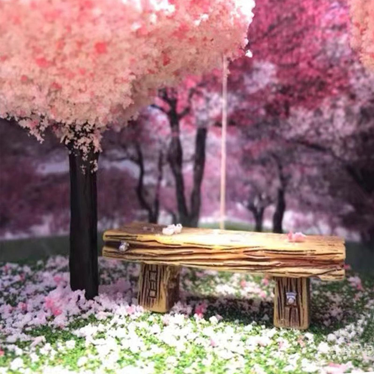 HUAXIUZH bench in a small garden diorama offers an eye-catching focal point.