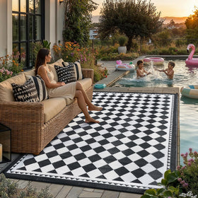 HUGEAR outdoor rug 6x9 in black and white plaid, waterproof for decks and patios.