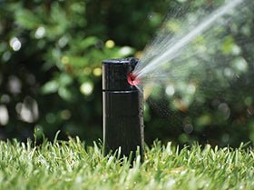 Hunter PGP-adj rotor head adjustment tool in use enables quick spray pattern tuning.