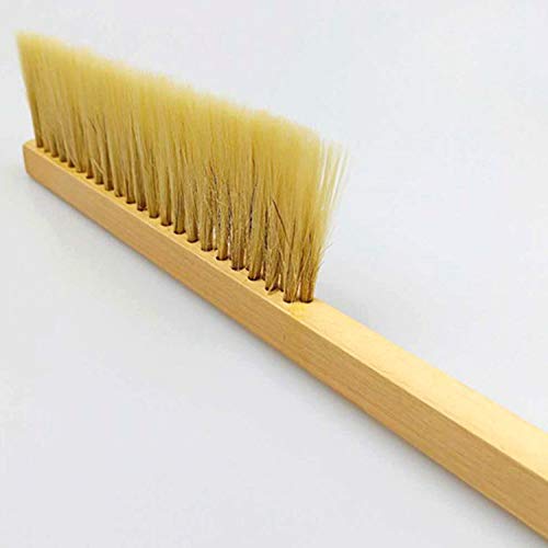 HunterBee brush in use on hive frames during routine inspections.