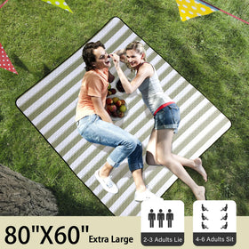 HX&OD picnic blanket 80x60 unfolded on the beach showing a clean surface.