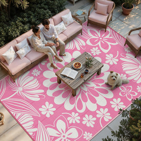 Ileading outdoor rug with pink floral reversible pattern for patios and decks.