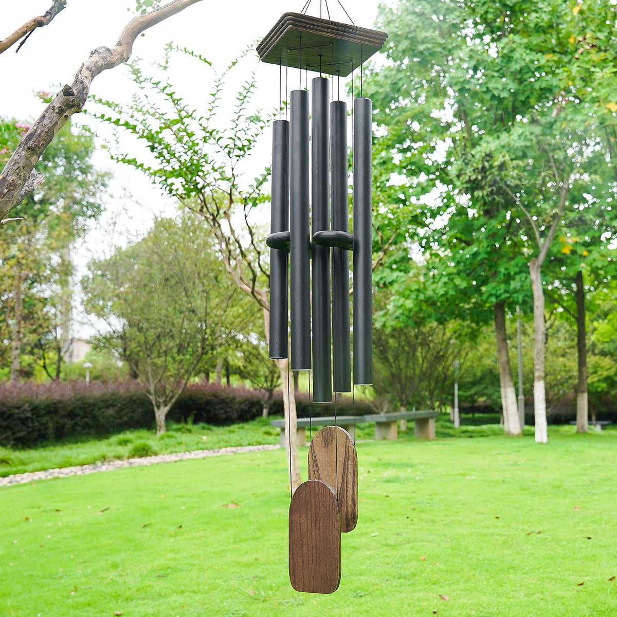 Implication black wind chime outdoor decor enhances garden ambience.