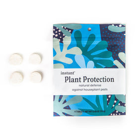 Instant Biologics tablets dissolving in water for easy pest control.