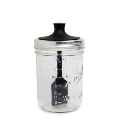Jarware silicone black basting brush lid on a wide-mouth jar for precise sauce application.