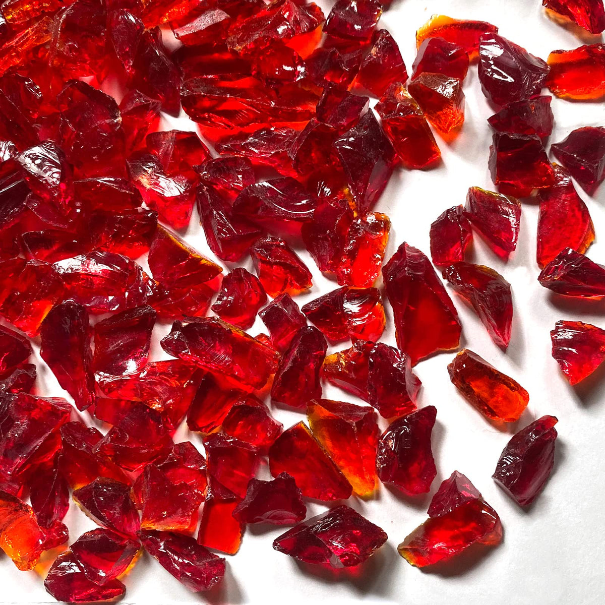 Irregular dark red glass pieces ideal for crafts and decorative borders.