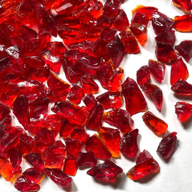 Irregular dark red glass pieces ideal for crafts and decorative borders.
