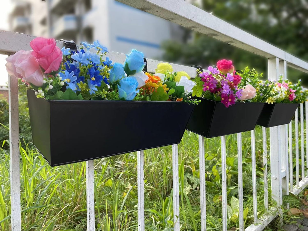 Herbs thriving in a JFMAMJ window-railing planter box for a convenient kitchen garden.