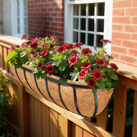 JINYICOCO liners in a container garden setup with flowers.