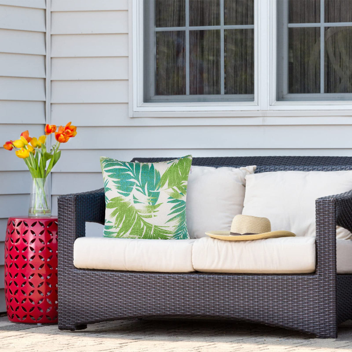 JMGBird palm leaf pattern white and blue cushion adds tropical flair.
