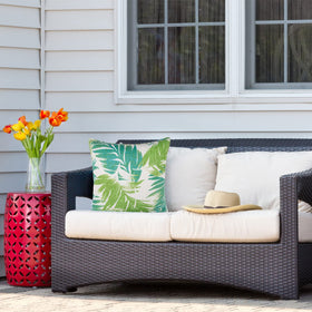 JMGBird palm leaf pattern white and blue cushion adds tropical flair.