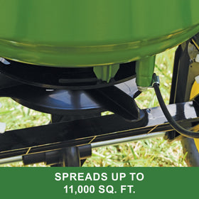 John Deere spreader in lawn application delivering even coverage.