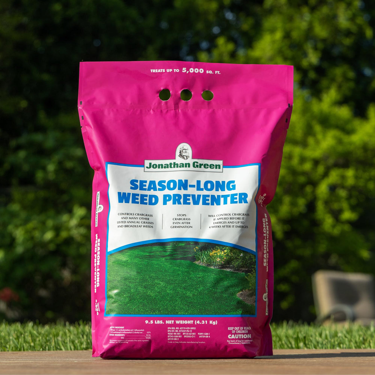 Granular application of Jonathan Green Season-Long Weed Preventer on the lawn.