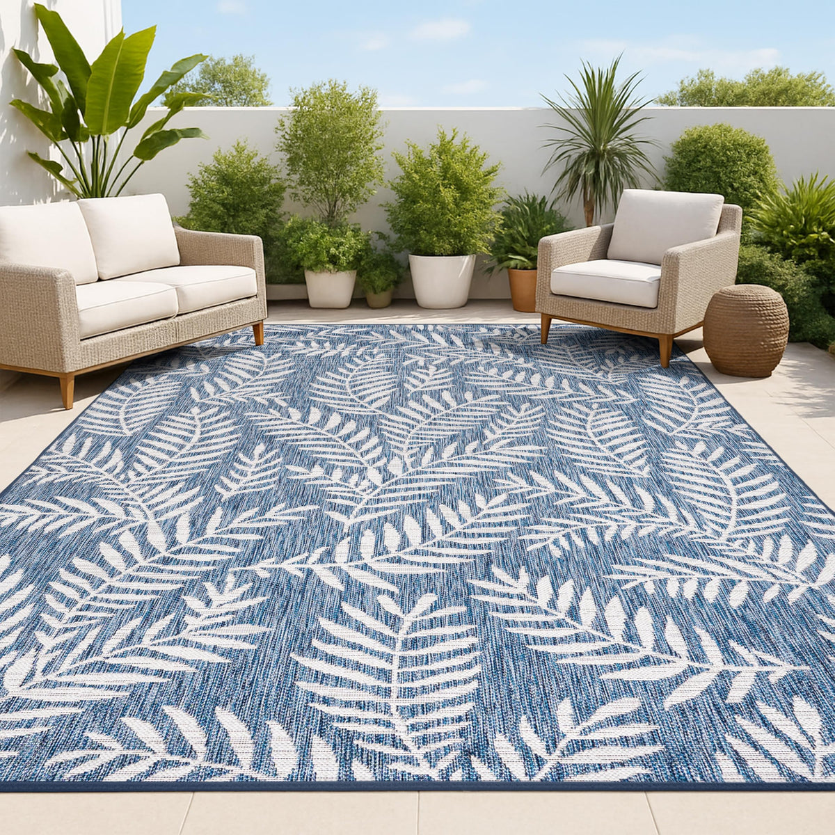 Jonathan Y palm frond pattern rug in navy and ivory for versatile indoor-outdoor use.