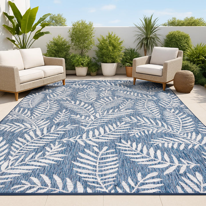 Jonathan Y palm frond pattern rug in navy and ivory for versatile indoor-outdoor use.