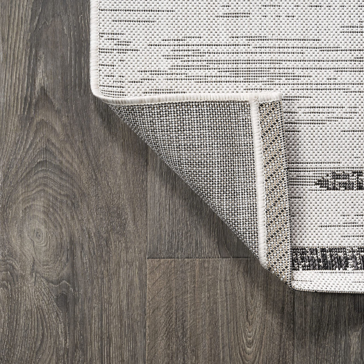 Jonathan Y Stripe Geometric Rug 5x8 at entryway, chic Moroccan-inspired touch