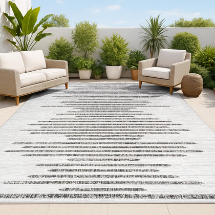 Jonathan Y stripe geometric rug in ivory and black for durable indoor-outdoor use.