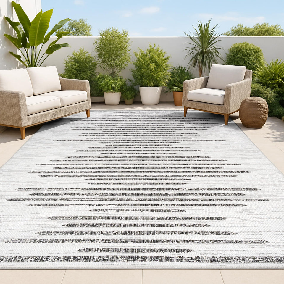 Jonathan Y stripe geometric rug in ivory and black for durable indoor-outdoor use.