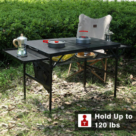 Portable JOUYEK folding grill table setup for a picnic or camp