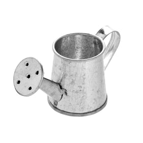 Juvale mini watering can on window sill with artificial flowers