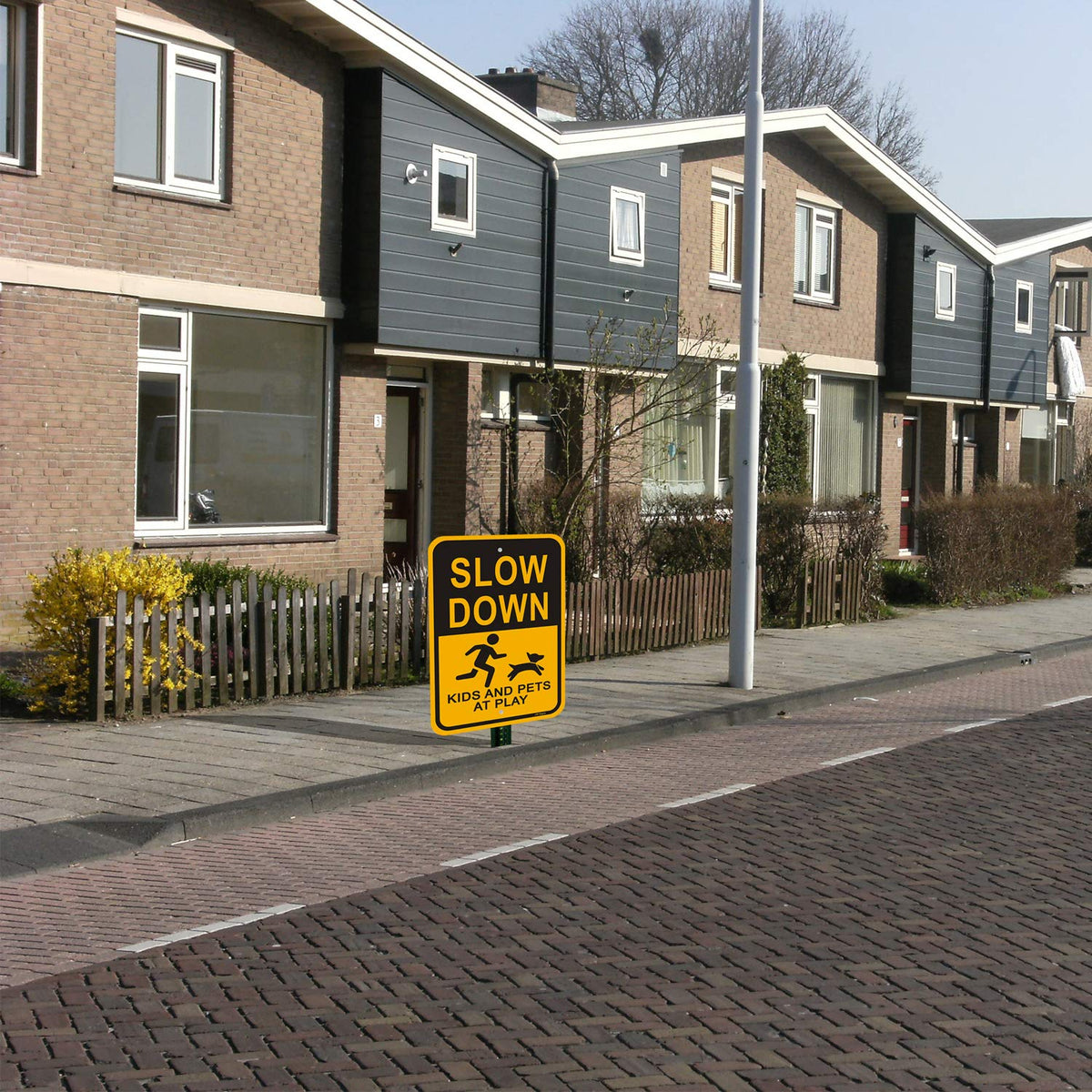 JW Signs Slow Down sign installed in yard to alert neighbors