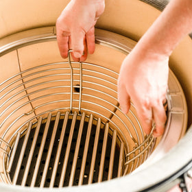 Divider in use illustrating two-zone cooking on Kamado Joe.
