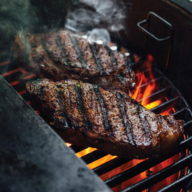 Kamado Joe sear marks on meat highlight rich flavors and crust formation.