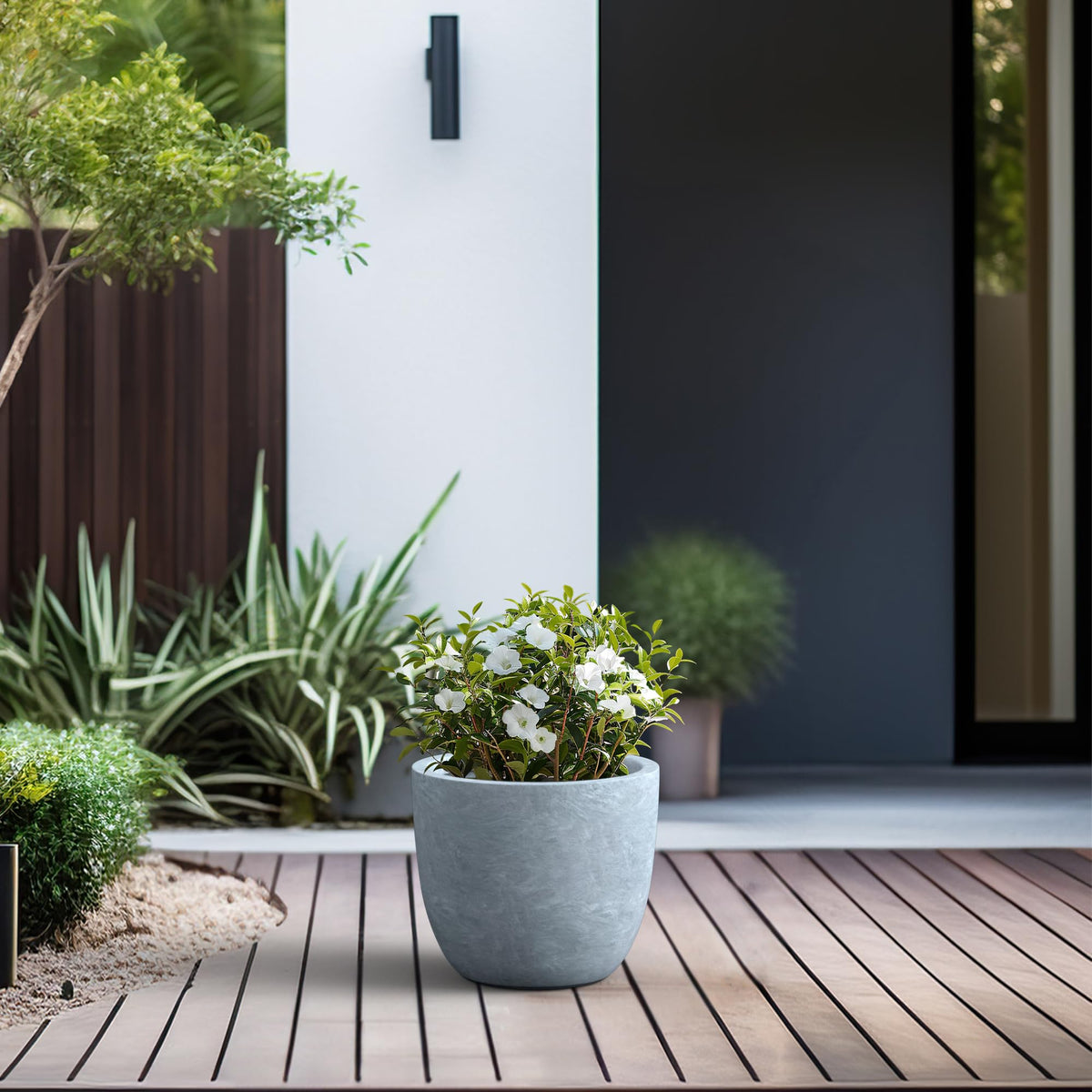 Kante 14-inch round concrete planter on outdoor patio, durable weather-ready design
