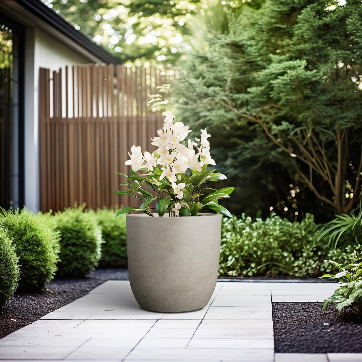 Kante 16.5-inch round concrete planter rubber plug for indoor or outdoor setups.