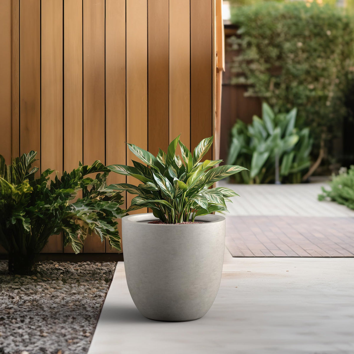 Kante 18-inch round concrete planter, drainage hole visible for water management