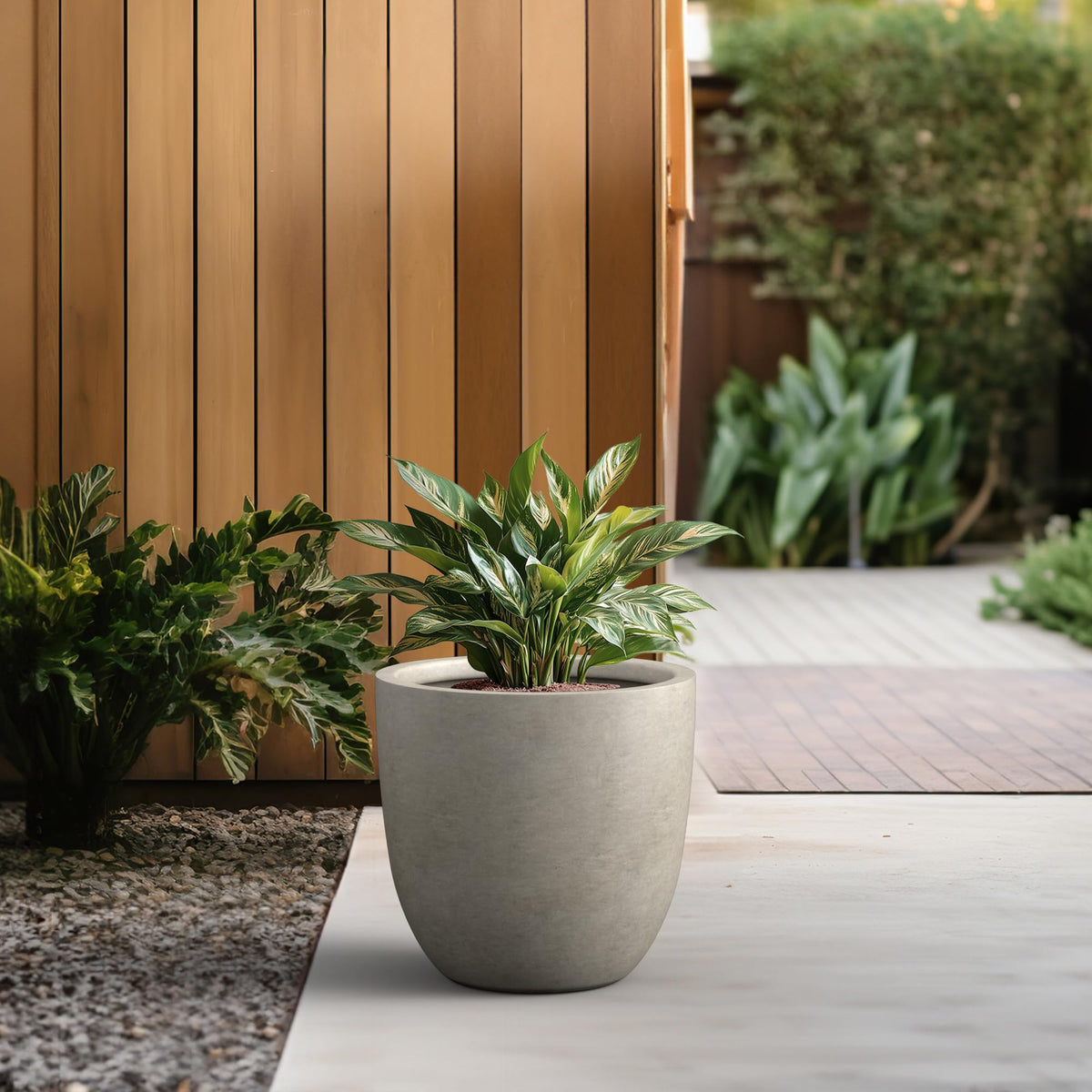 Kante 18-inch round concrete planter drainage hole with rubber plug for water control.