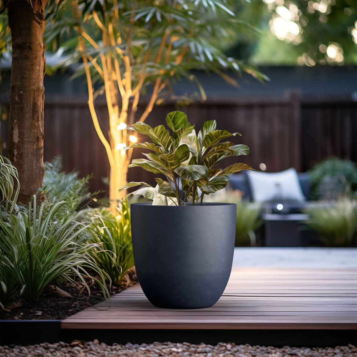 Kante 18inch round planter outdoor patio scene highlights weather-ready durability